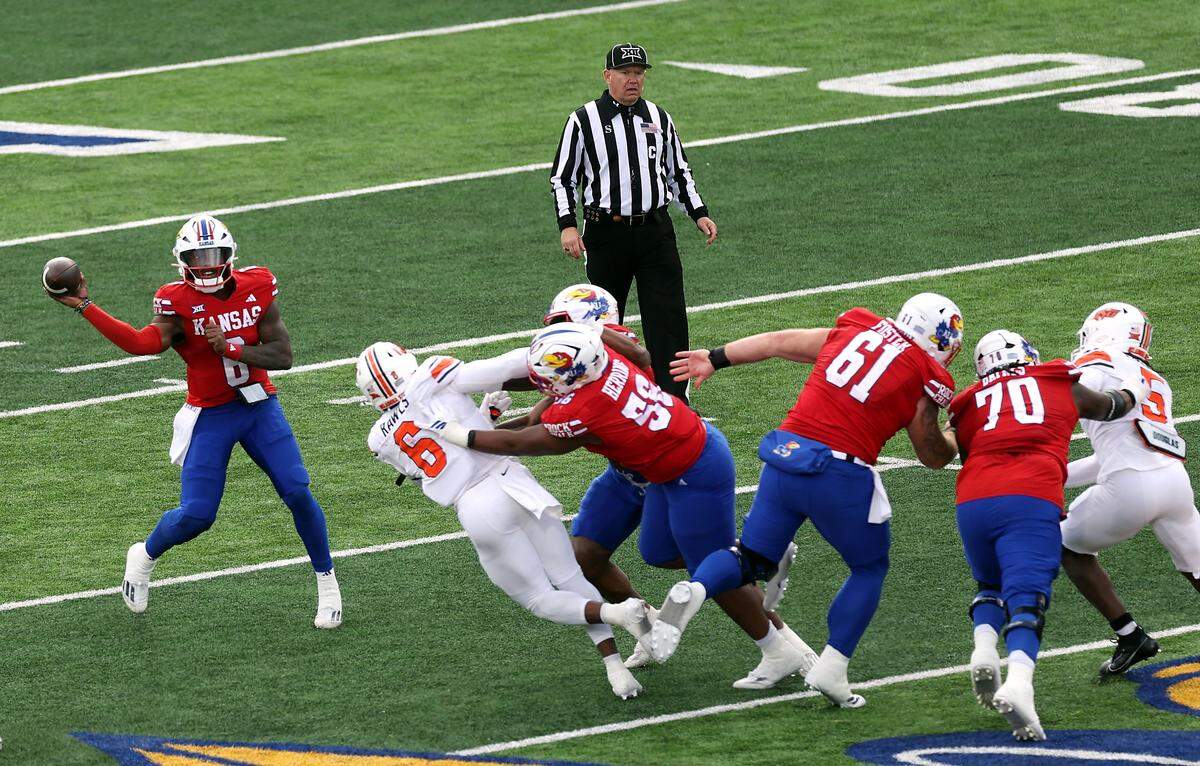 Kansas Jayhawks quarterback Jalon Daniels, at far left, throws during a Saturday, Nov. 1, 2025 college football game against the Oklahoma State Cowboys at David Booth Kansas Memorial Stadium in Lawrence, Kansas.