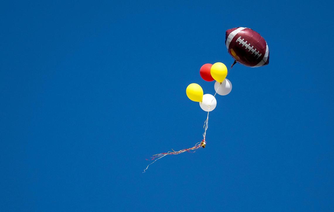 A football balloon floats through the sky after a shooting broke out following the Kansas City Chiefs Super Bowl LVIII victory parade on Wednesday, Feb. 14, 2024, in Kansas City.