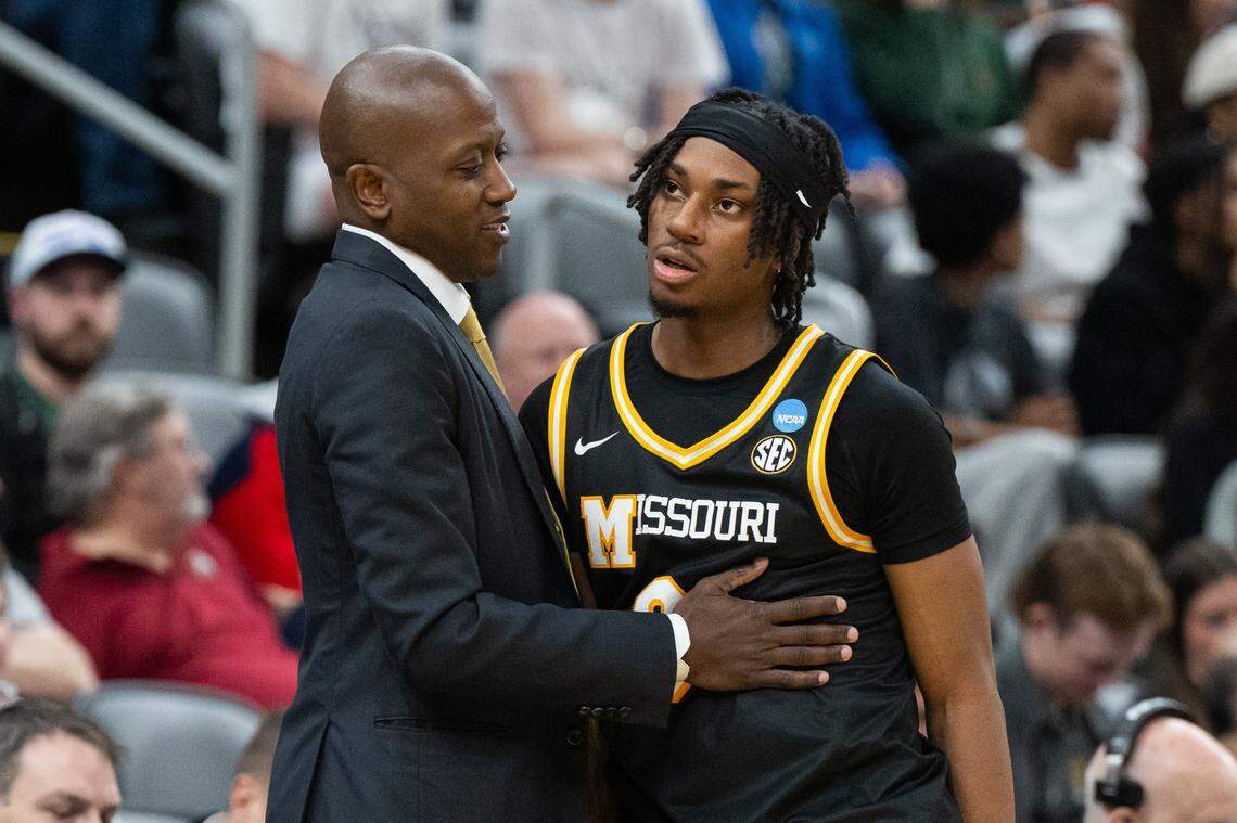 Missouri Tigers head coach Dennis Gates consoles Missouri Tigers guard Anthony Robinson II (0) in the final seconds of the Tigers first-round NCAA Tournament matchup vs. the Miami Hurricanes at Enterprise Center in St. Louis on Friday, March 20, 2026.