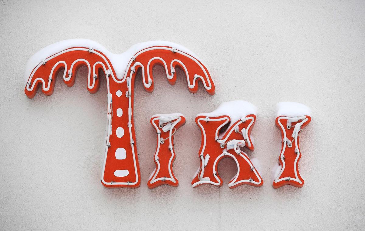 Snow tops the sign at Tiki Taco Sunday, Jan. 5, 2025, in downtown Overland Park.