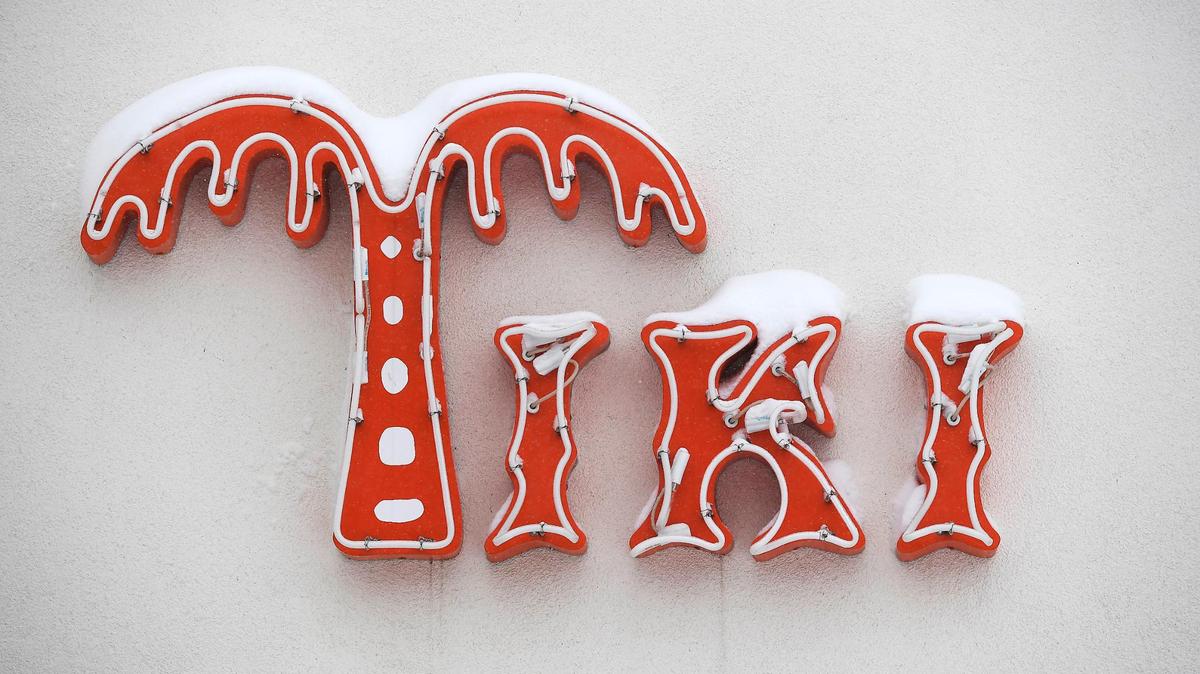Snow tops the sign at Tiki Taco Sunday, Jan. 5, 2025, in downtown Overland Park.
