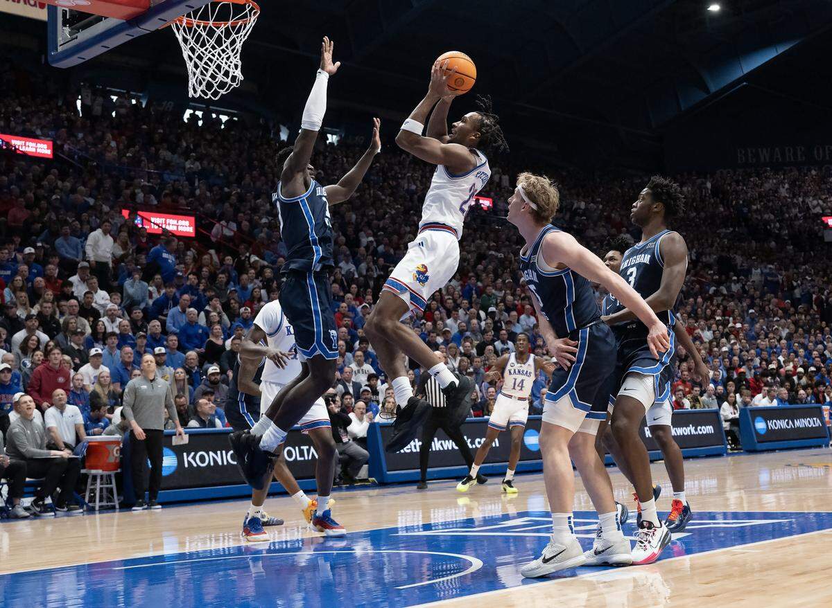 Kansas Jayhawks guard Darryn Peterson (22) goes up for two as BYU Cougars center Keba Keita (13) defends in the first half at Allen Fieldhouse on Saturday, Jan. 31, 2026, in Lawrence.