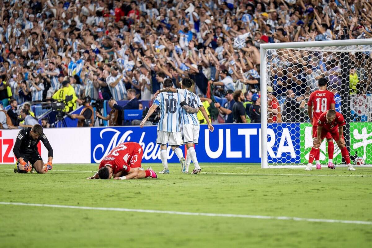 Argentina forward Lionel Messi (10) and midfielder Thiago Almada (16) celebrate after forward Lautaro Martínez (22) scores a goal in overtime against Switzerland during the FIFA World Cup quarterfinal at Kansas City (Arrowhead) Stadium on Saturday, July 11, 2026.