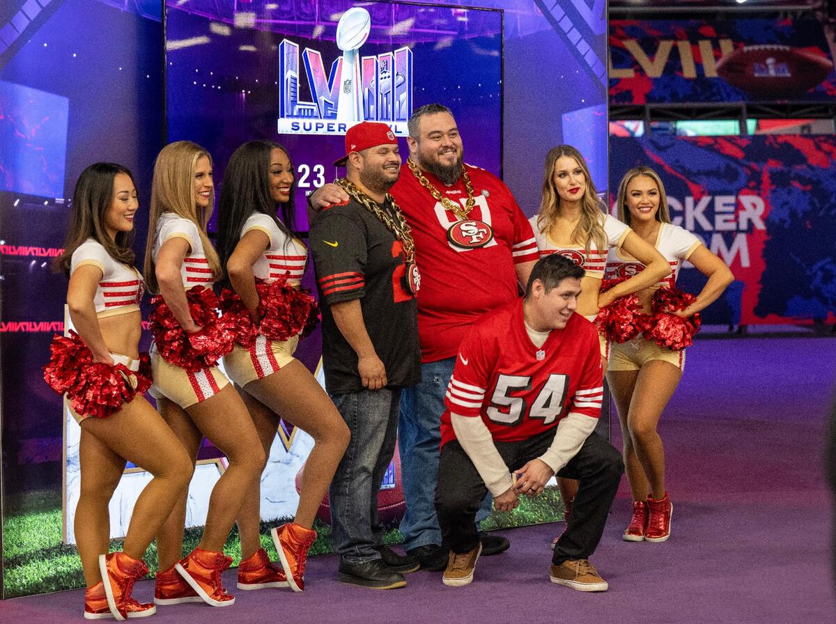 San Francisco 49ers fans posed with some of the teams’ cheerleaders as they visited the Super Bowl Experience, on Thursday, Feb. 8, 2024, in Las Vegas, Nevada.