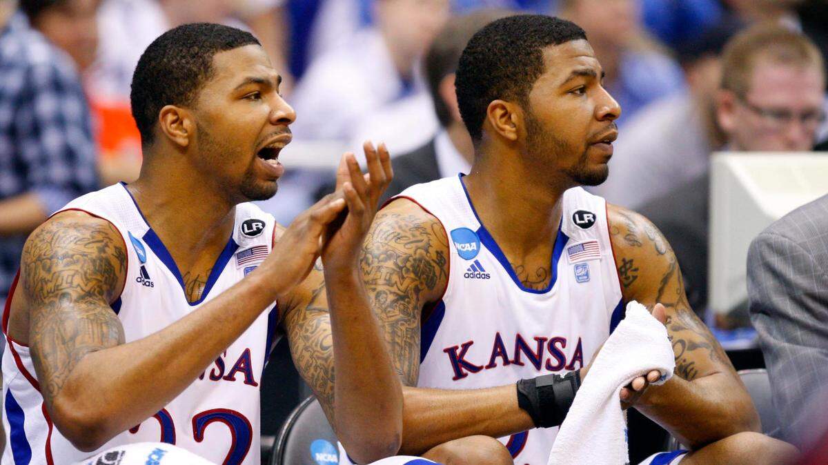 Kansas Jayhawks forwards Marcus Morris (22) and Markieff Morris (21) react on the bench during the 2011 NCAA Tournament against the Richmond Spiders at the Alamodome in San Antonio on March 25, 2011.