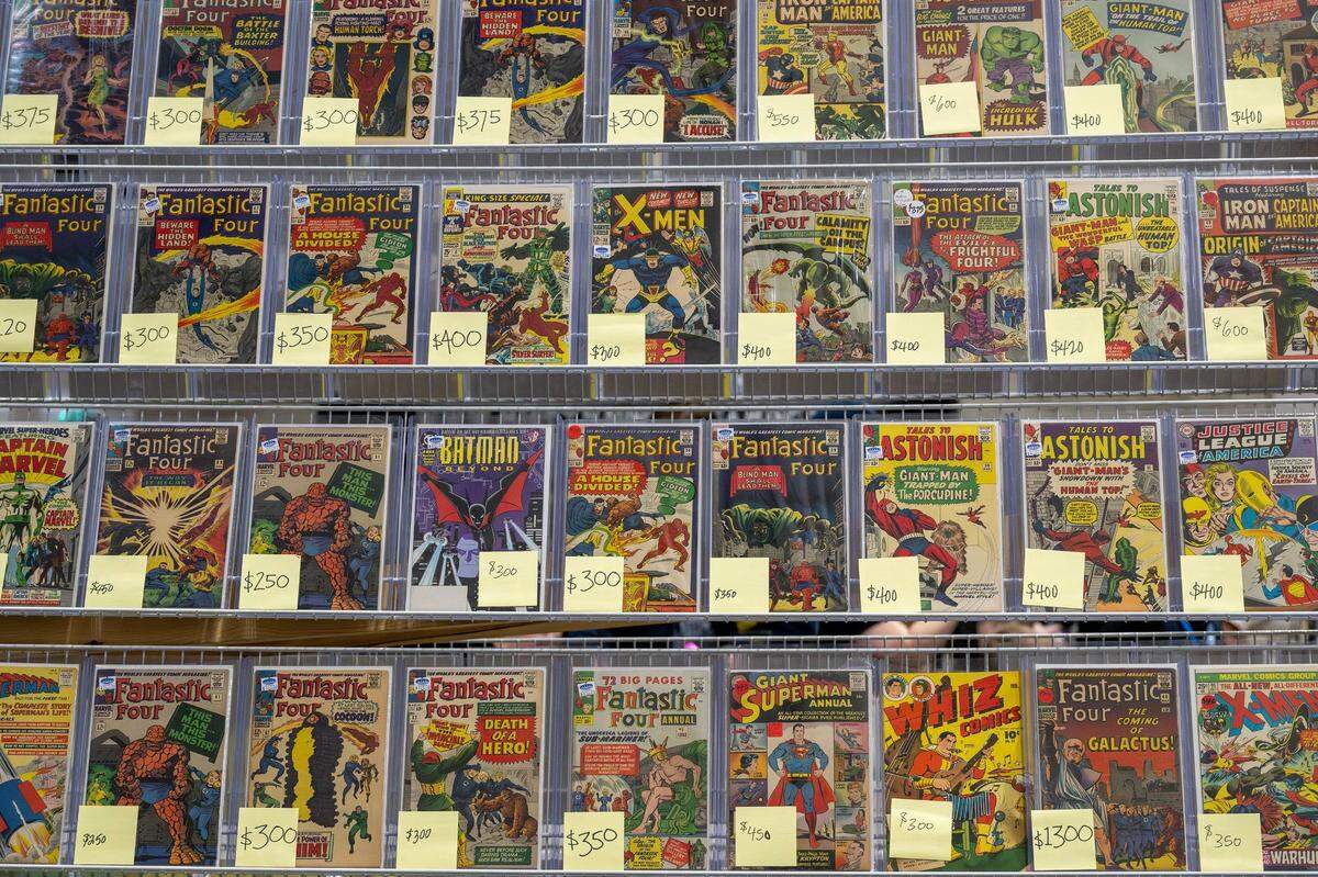 A variety of comics from the Elite Comics booth are displayed on a rack during Planet Comicon at the Kansas City Convention Center on Friday, March 21, 2025.