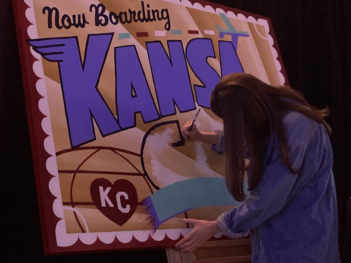 Graphic designer Jadie Arnett of Kansas City worked live on Thursday, May 7, at Municipal Auditorium, to create a large version of a postcard she designed for Visit KC’s annual event, which touted Kansas City becoming a worldwide destination for the 2026 FIFA World Cup.