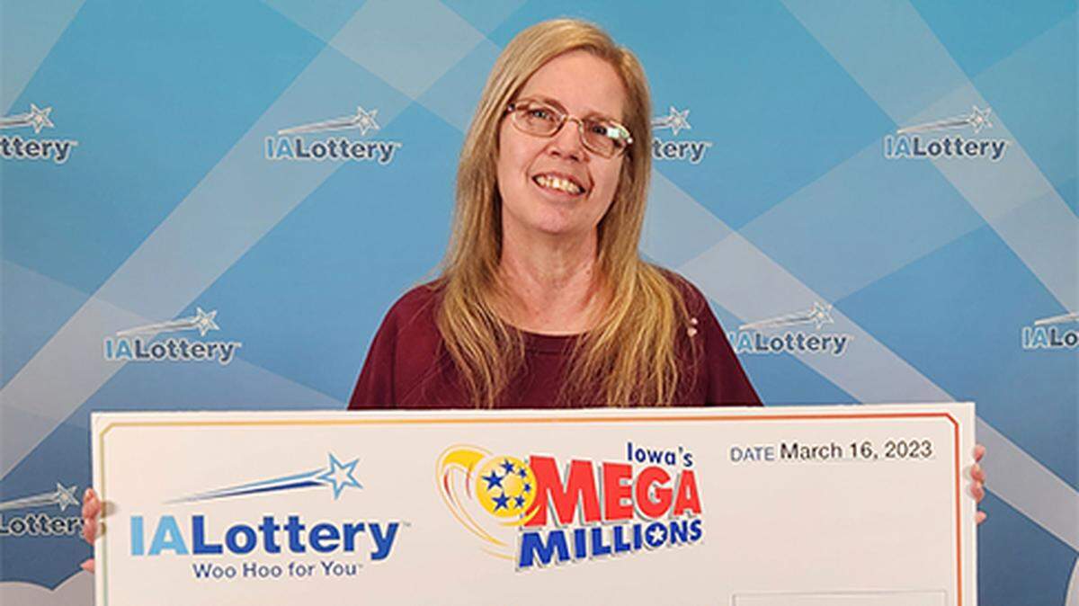 Marla Ballard with her oversized check.