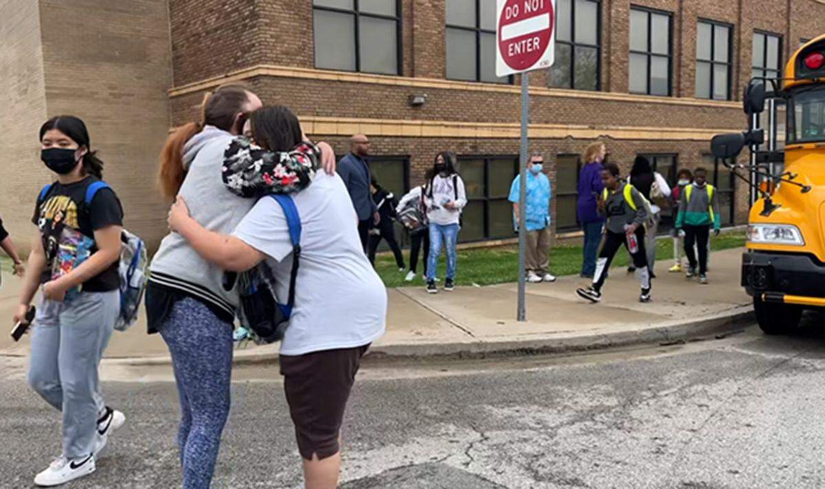 Students at Northeast Middle School in Kansas City were reunited with family after being released early aftera one person was injured in a stabbing Tuesday, April 12, 2022, in the Kansas City Public Schools district, police said. The victim was taken to a hospital with life-threatening injuries, said Officer Donna Drake, a spokesperson for the Kansas City Police Department. One person has been detained.