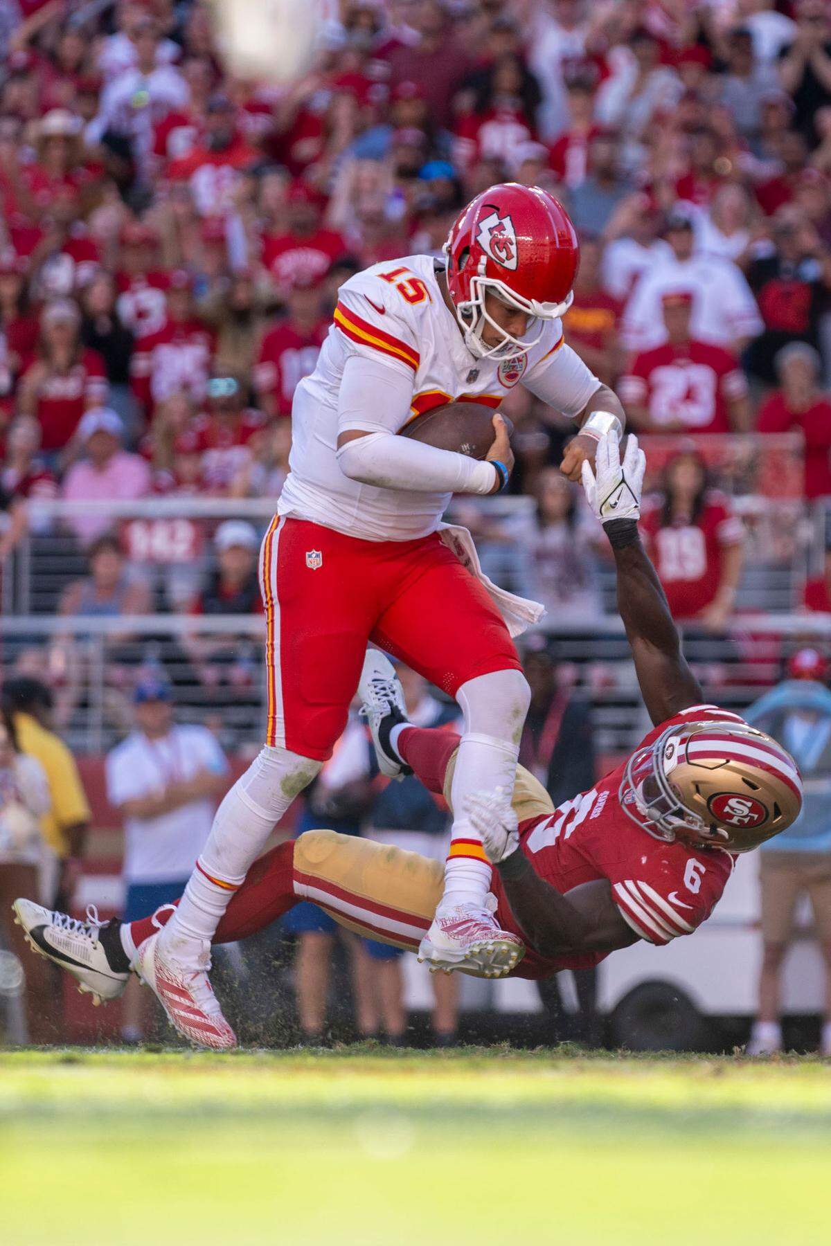 Kansas City Chiefs quarterback Patrick Mahomes (15) scores a touchdown against San Francisco 49ers safety Malik Mustapha (6) during the fourth quarter at Levi’s Stadium.