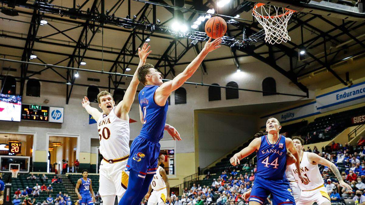 Kansas guard Christian Braun drives past Iona forward Trey James to the basket as Kansas’ Mitch Lightfoot boxes out during the first half of the Jayhawks’ win Sunday in the ESPN Events Invitational third-place game.