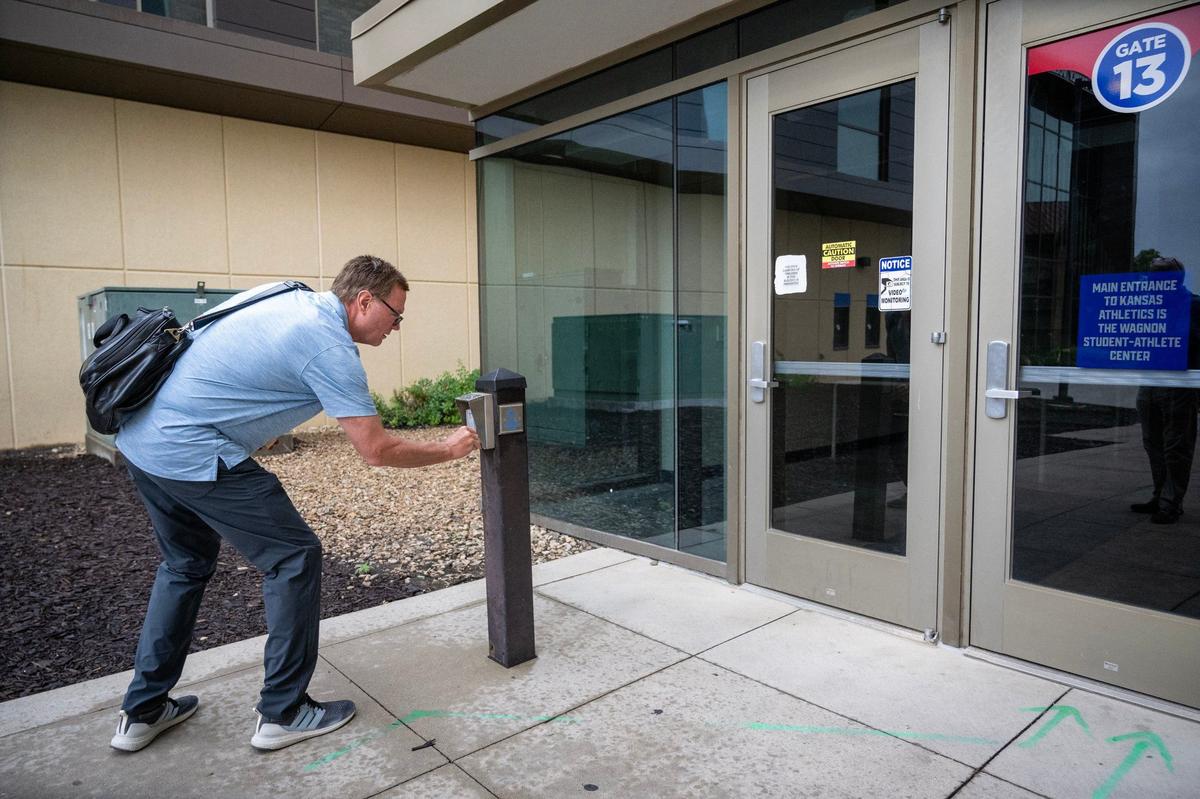 Amid construction at Allen Fieldhouse, Kansas coach Bill Self punches in a code to open the door so he can get into his office adjoining the hallowed arena.