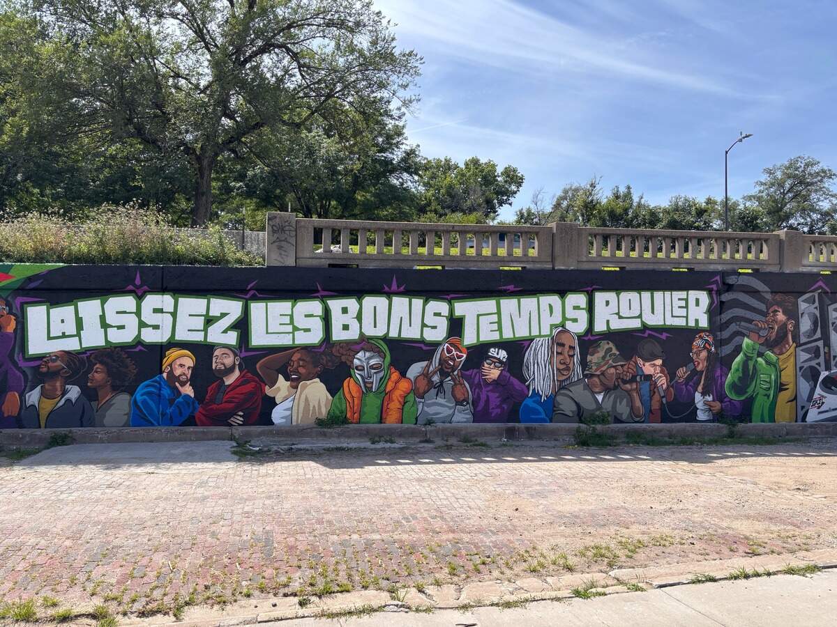At the center of the mural is the phrase “Laissez les bons temps rouler,” or “Let the good times roll.”