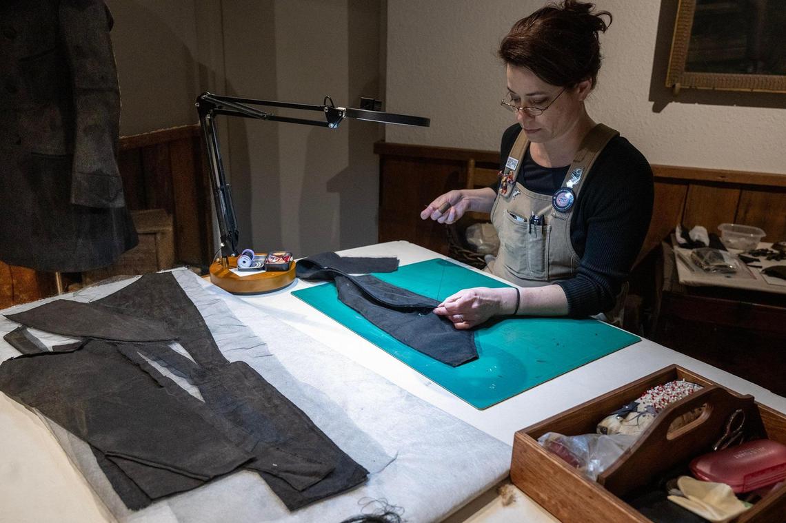 Textiles conservator Holly Messinger works on pieces of man’s frock coat she was preserving at the Arabia Steamboat Museum in Kansas City on Thursday, April 18, 2025. The coat, recovered from the Arabia steamboat which sank in 1856, has been stored in a freezer awaiting preservation since the recovery of the ship and its cargo in 1988.
