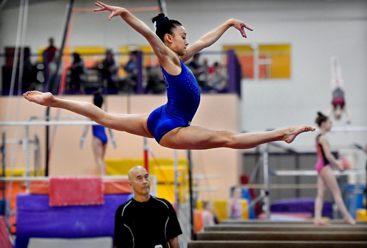 Under the watchful eye of coach Al Fong, Leanne Wong perfects her routine on the balance beam during a recent practice at Great American Gymnastics Express in Blue Springs. The 15-year-old gymnast , who attends Blue Valley High School, recently won the American Cup in Greensboro, North Carolina, and has her sights set on making the U.S. Olympic team and earning a trip to Tokyo in 2020.