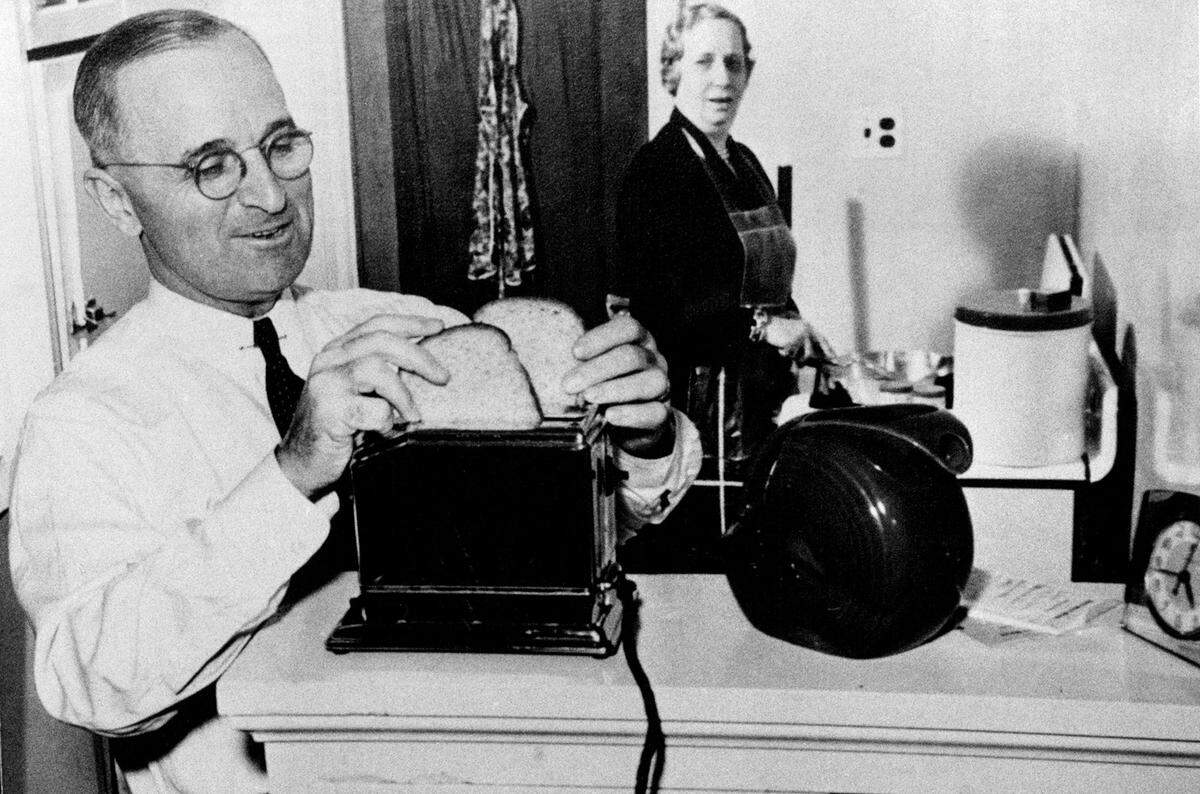President Harry S. Truman makes toast in the kitchen as his wife, Bess, looks on in this undated photo.