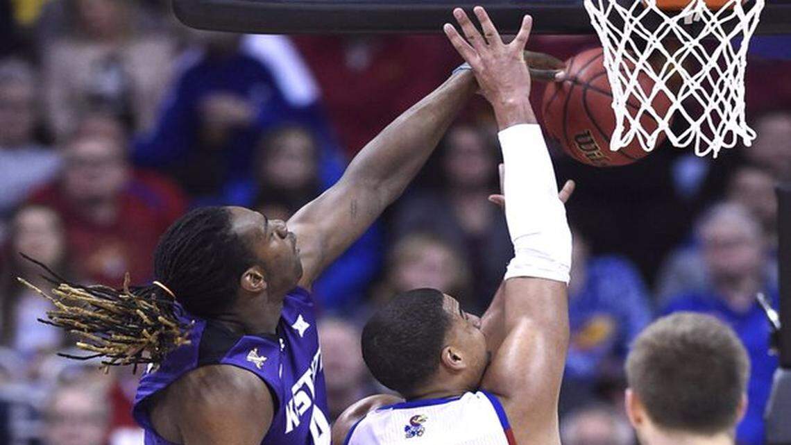 K-State forward D.J. Johnson knocked the ball away from KU forward Landon Lucas in their Big 12 Tournament game on Thursday at the Sprint Center.
