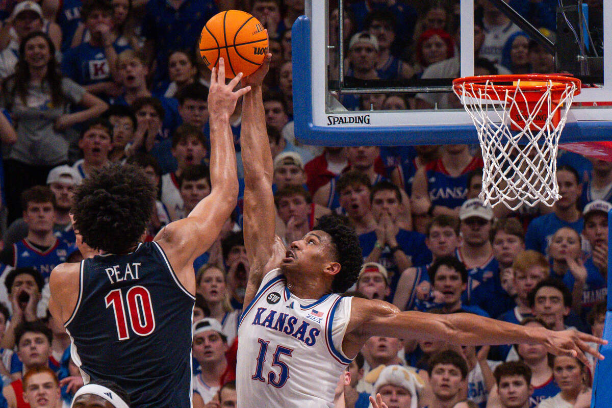 Kansas Jayhawks forward Bryson Tiller (15) blocks the shot of Arizona Wildcats forward Koa Peat (10) in the first half of the Jayhawks game vs. the Arizona Wildcats on Monday, Feb. 9, at Allen Fieldhouse.
