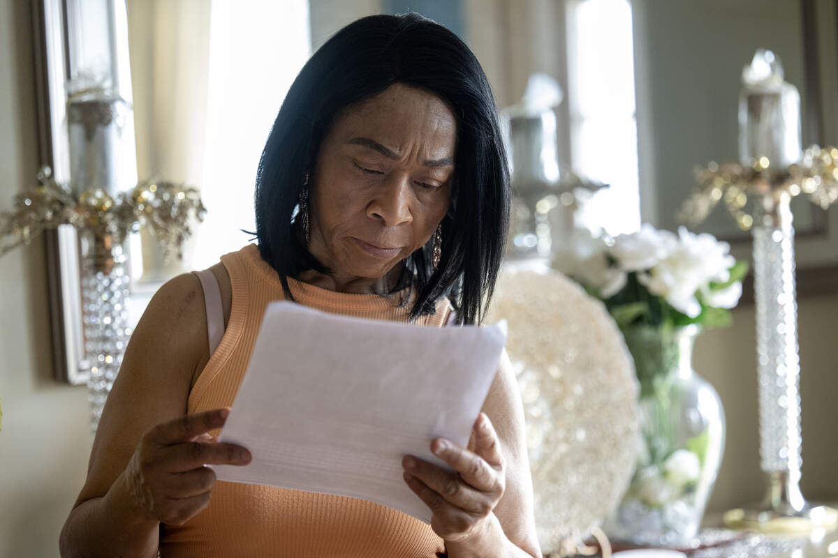Diahna Carroll looks over a copy of a Kansas City Police Department crash report that has no mention of a police pursuit in the Jan. 2, 2024, crash that claimed the life of her husband, Alphonso “Duke” Carroll, 60. 