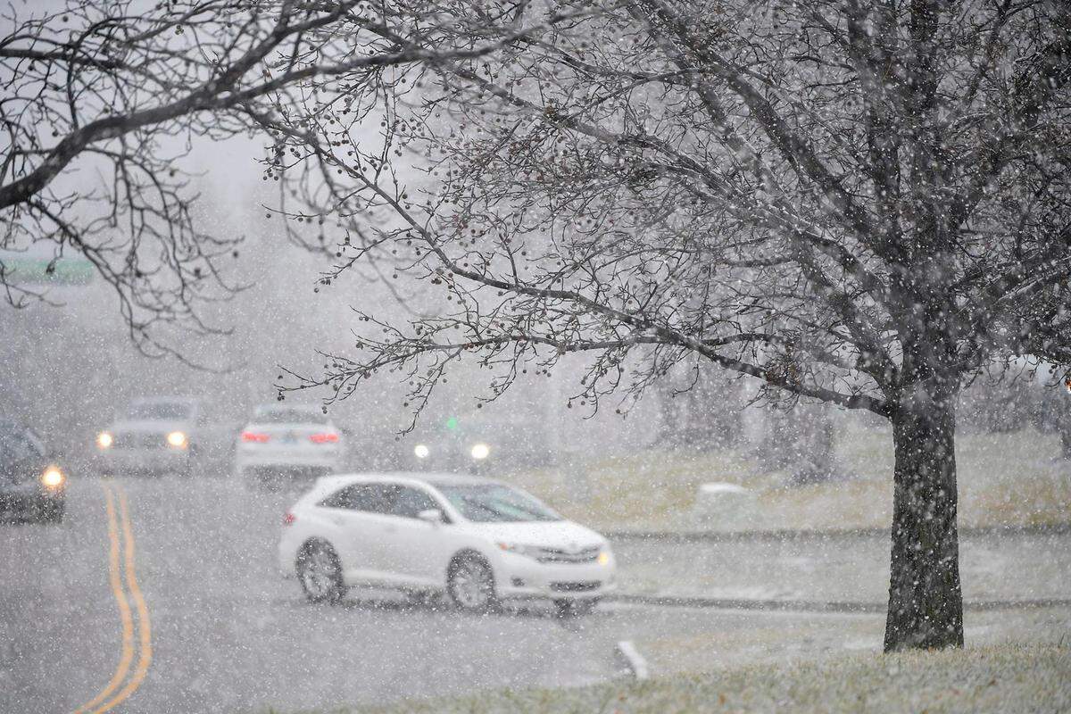 Snow was falling and visibility was decreasing as vehicles navigated the roads in a parking lot in Shawnee, Kansas, on Monday, Jan. 8, 2024.