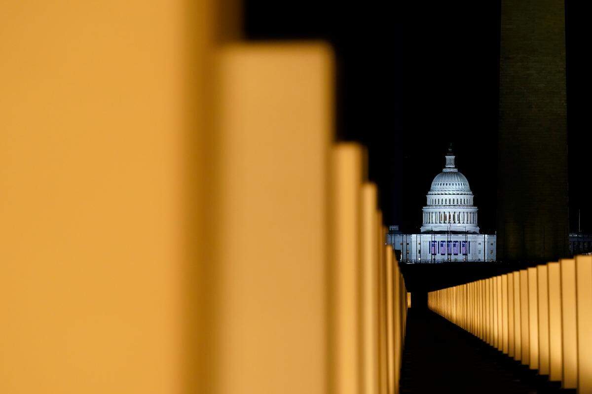 Lights surround the Lincoln Memorial Reflecting Pool, placed as a memorial to COVID-19 victims Tuesday, Jan. 19, 2021, in Washington, after President-elect Joe Biden spoke, with the U.S. Capitol in the background.
