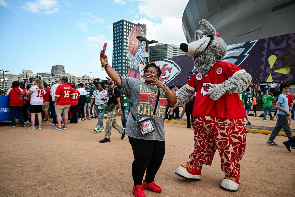 Shanita Hampton of Kansas City takes a selfie with Kansas City Chiefs mascot KC Wolf outside Caesars Superdome before Super Bowl LIX on Sunday, Feb. 9, 2025, in New Orleans.