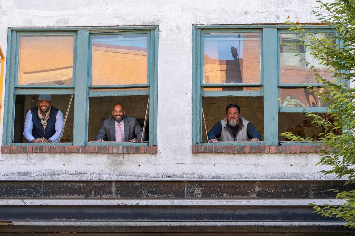 Shomari Benton, left, Jason Parson,Tim Duggan and stand by a window inside Boone Theater on Tuesday, Oct. 15, 2024, in Kansas City.