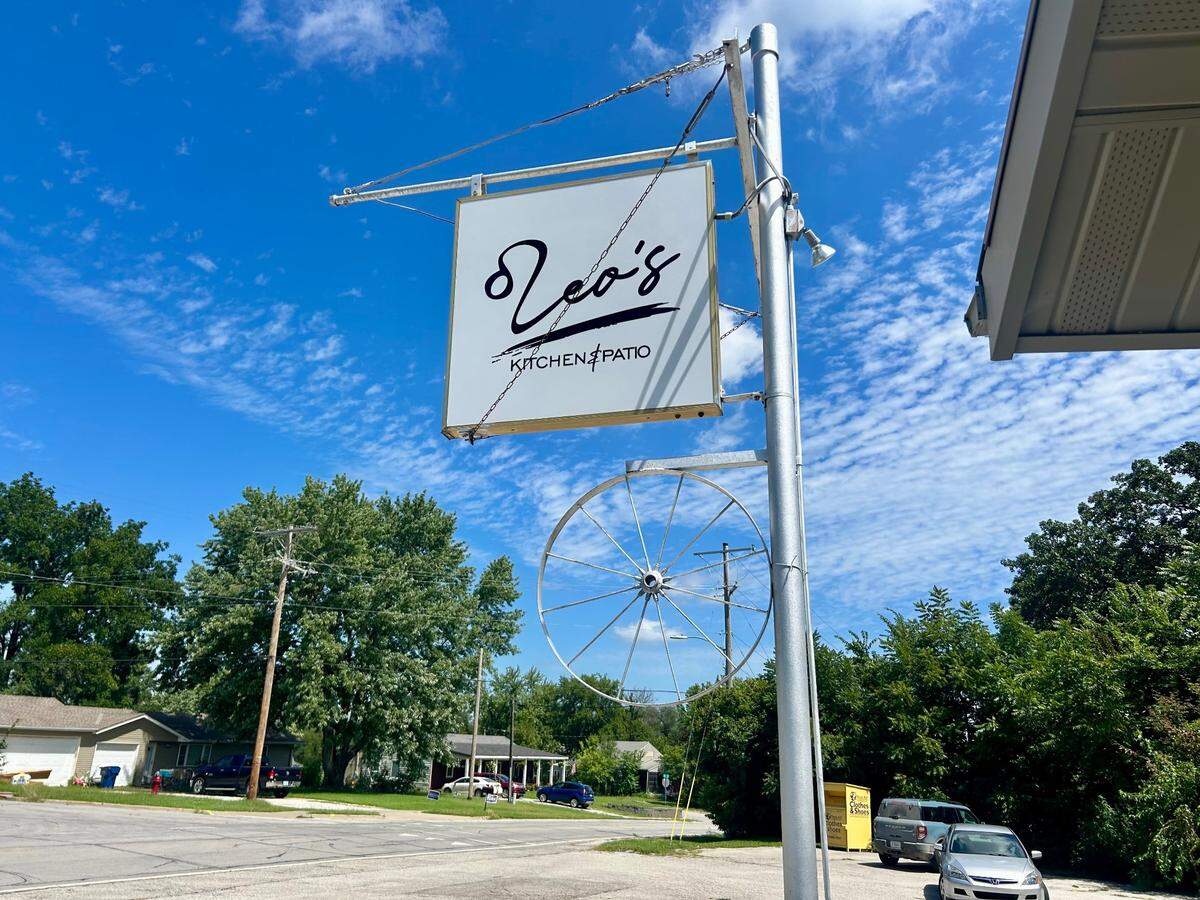 The silver wheel is still hanging outside an old building in De Soto, even after its name change.