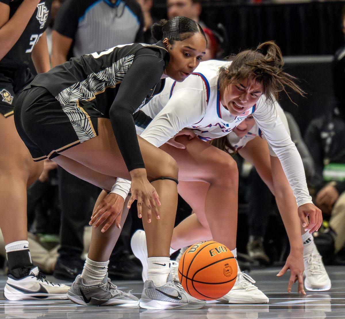 UCF Knights center Mahogany Chandler-Roberts (33) and Kansas Jayhawks forward Regan Williams (24) battle for position during the fourth quarter of the Big 12 Women's Basketball Tournament at T-Mobile Center on Wednesday, March 4, 2026, in Kansas City.