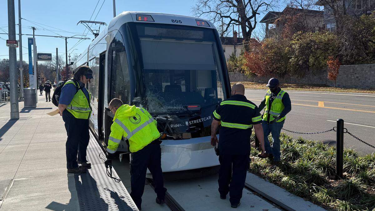 People inspect a KC Streetcar after it sustained damage from a collision with a box truck near Dr. Martin Luther King Jr. Boulevard and Brookside Boulevard on Nov. 22, 2025.