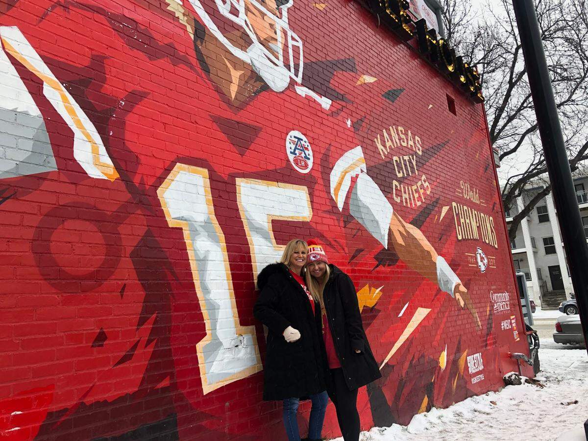 Madison Usher, 23, snaps a photo with her mother, Jane Usher, in front of the Chiefs mural on the Westport Ale House ahead of the 2021 Super Bowl game. Feb. 7, 2021.