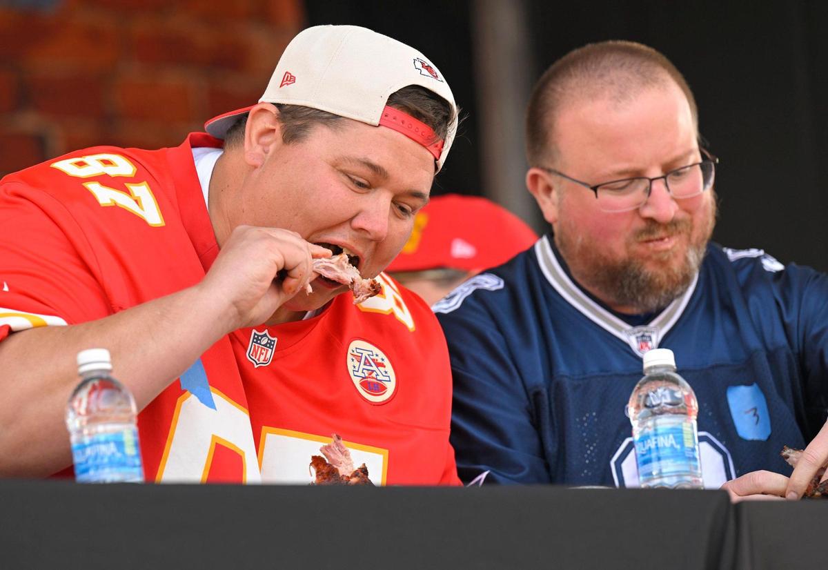 Ryan McCluskey, left, of Kansas City, chowed down on ribs beating nine other contestants, including Brando Rusche of Sibley, Iowa, in a rib eating contest at the KC Smoke Show at the NFL Draft on Saturday, April 29, 2023, in Kansas City. McCluskey is a teacher at Smithville High School in Smithville, Missouri.
