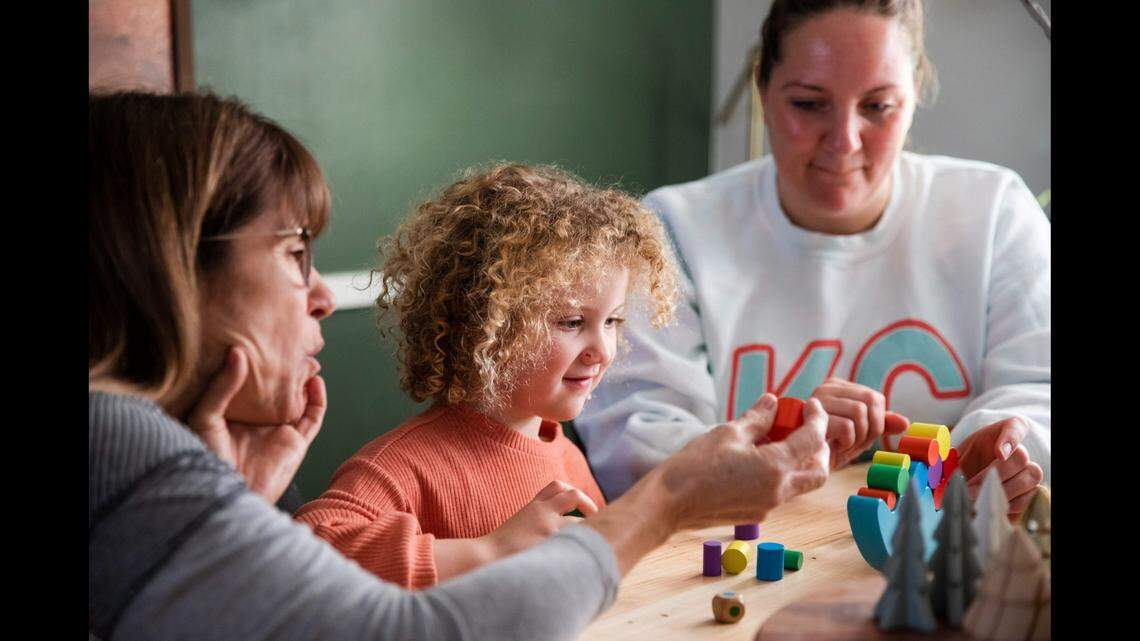 Parent Educator Debra Stevenson, left, works with Amira Prier and her mother, Mia Prier..