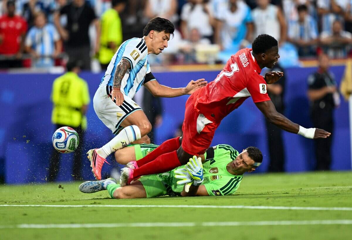 Argentina goalkeeper Emiliano Martínez (23) slides out to stop the Switzerland attack in the first half of the Argentina vs. Switzerland 2026 World Cup Quarterfinal football match at Kansas City (Arrowhead) Stadium in Kansas City on Saturday, July 11, 2026.