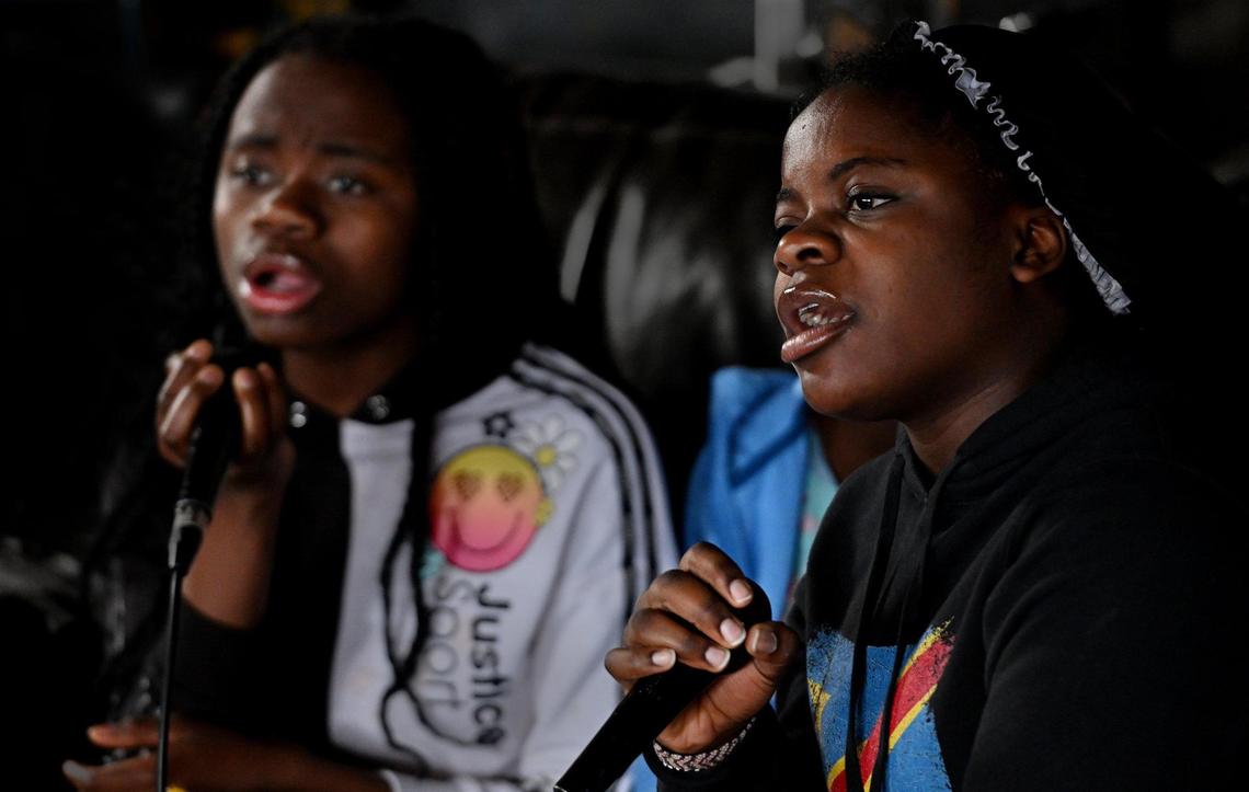 Aline Kitungano, left, and Bora Wilondja rehearsing in the choir’s practice space, a two-car garage in the city’s Northeast area. 