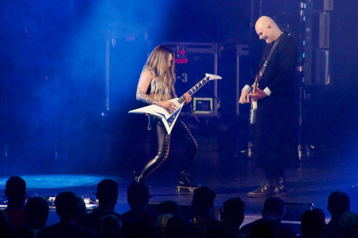 Kiki Wong, left, and Billy Corgan of The Smashing Pumpkins perform at Starlight Theatre in Kansas City on Wednesday. Wong joined The Smashing Pumpkins earlier this year following an open casting call for a new touring guitarist.