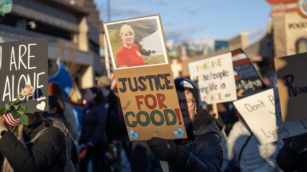 Demonstrators walk along Emanuel Cleaver II Boulevard during a vigil for victims of U.S. Immigration and Customs Enforcement on Saturday, Jan. 10, 2026, in Kansas City.