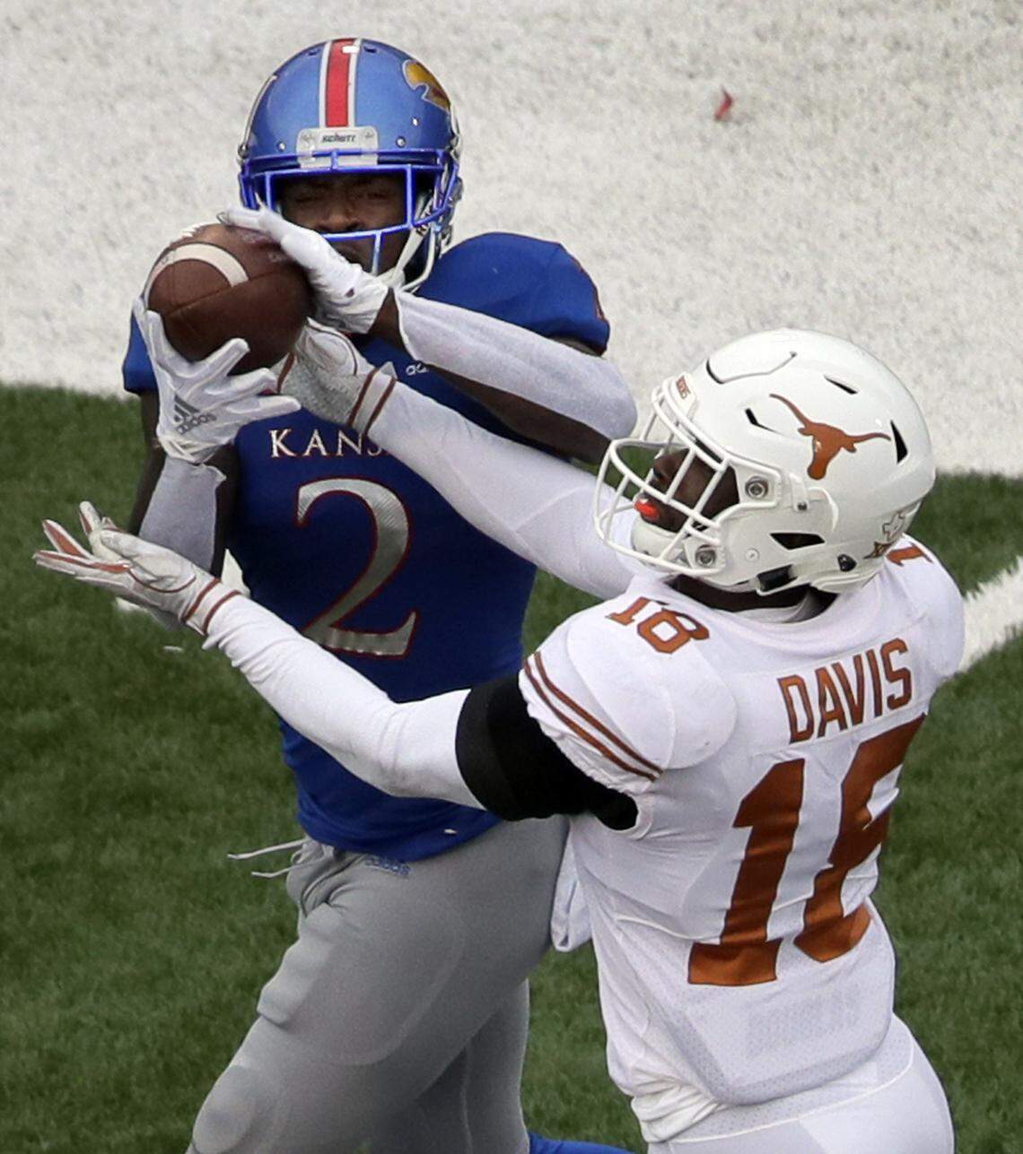 Kansas receiver Daylon Charlot catches a TD pass under coverage from Texas defensive back Davante Davis.