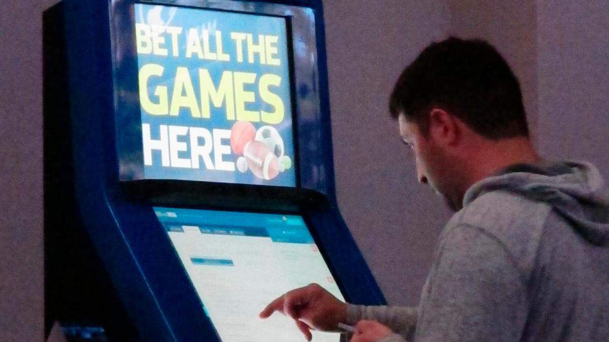 This June 21, 2019, file photo shows a person making bets at a William Hill kiosk inside the Ocean Casino Resort in Atlantic City, N.J. Missouri appears unlikely to pass legalized sports betting legislation this year after a proposal stalled in the Senate. The bill sparked a fight over video slot machines.
