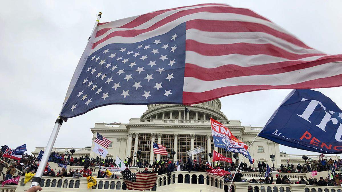 Rioters flew an American flag upside down, a signal of national distress, during the Jan. 6, 2021, Capitol insurrection.