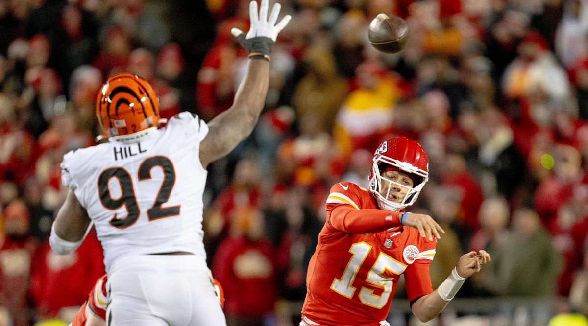 Kansas City Chiefs quarterback Patrick Mahomes (15) throws around the outstretched arm of Cincinnati Bengals defensive tackle BJ Hill (92) during an NFL football game at GEHA Field at Arrowhead Stadium on Sunday, Dec. 31, 2023, in Kansas City.