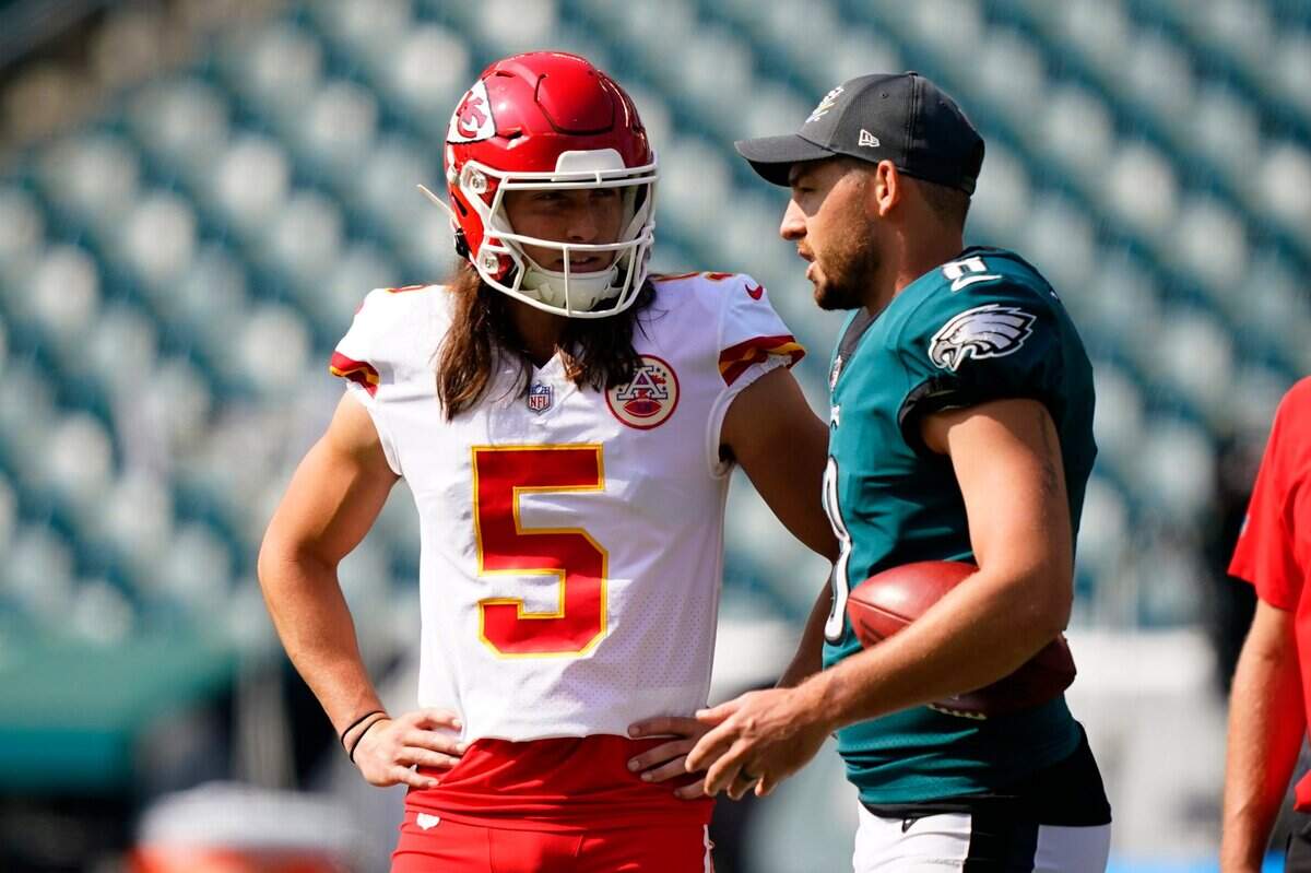 Kansas City Chiefs punter Tommy Townsend, left, chats with his Philadelphia Eagles counterpart, Arryn Siposs, before their teams’ game early this season.