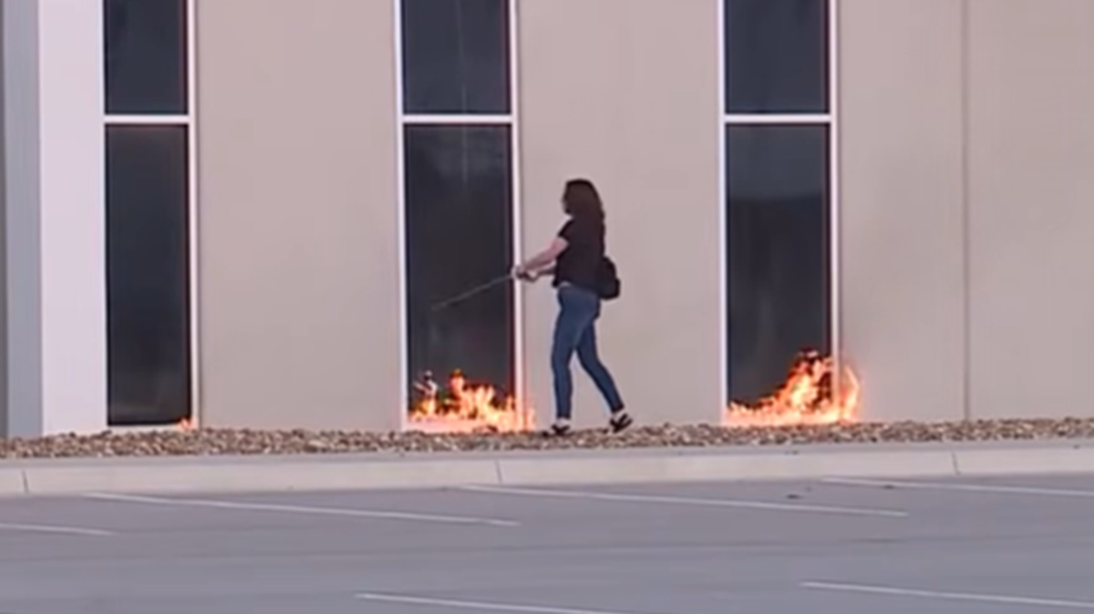 Federal authorities say this image shows Dara S. O’Connor, 30, setting fire to a warehouse that federal officials had considered as an Immigration and Customs Enforcement detention center.