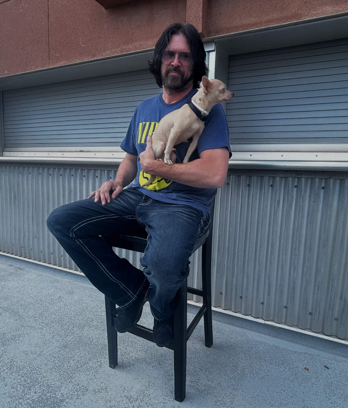 Steve Kramer and his chihuahua Grogu pose outside Kramer’s soon-to-open comedy club First Amendment Brew Haha.