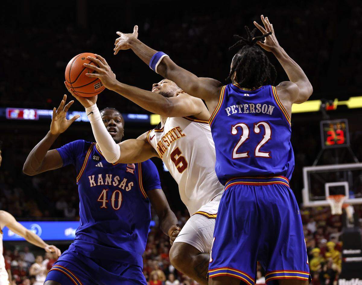 Joshua Jefferson #5 of the Iowa State Cyclones takes a shot between Flory Bidunga #40 and Darryn Peterson #22 of the Kansas Jayhawks in the first half of play at Hilton Coliseum on February 14, 2026 in Ames, Iowa.