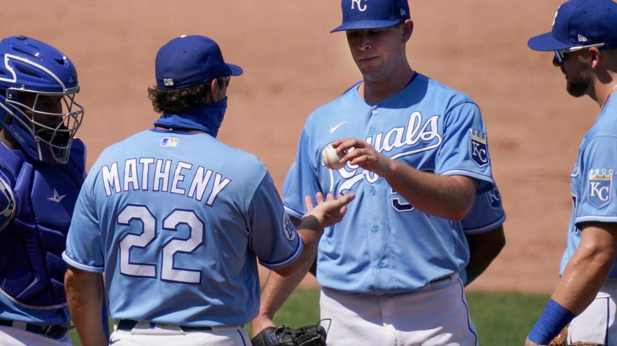 Kansas City Royals manager Mike Matheny (22) takes the ball from starting pitcher Kris Bubic (50) during the fourth inning of a baseball game against the Minnesota Twins at Kauffman Stadium in Kansas City, Mo., Sunday, Aug. 23, 2020. (AP Photo/Orlin Wagner)