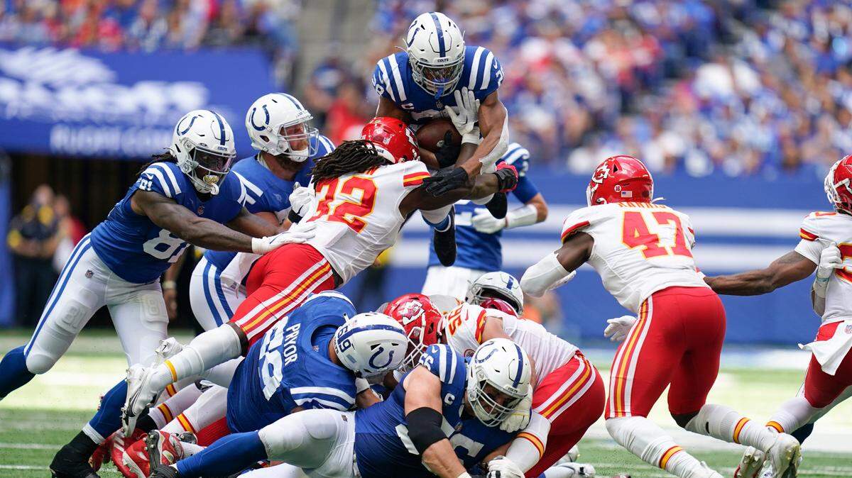 Indianapolis Colts running back Jonathan Taylor is tackled by Kansas City Chiefs linebacker Nick Bolton (32) on a fourth down during the second half of an NFL football game, Sunday, Sept. 25, 2022, in Indianapolis. Taylor was stopped short of the first down.