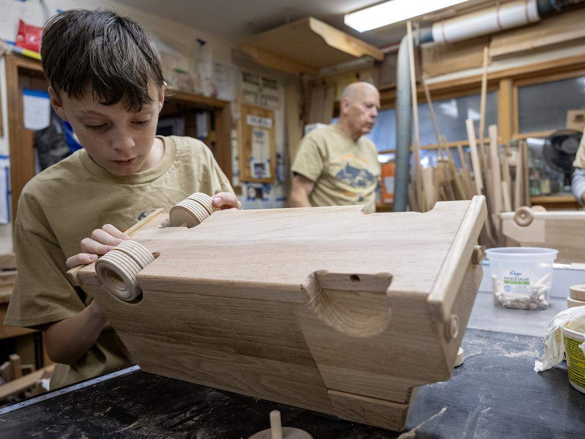 Volunteer Bryce Bradshaw, 13, of Independence, works on toy truck crafted from donated wood scraps on Tuesday, Dec. 2, 2025, in Lawrence, Kansas. The truck will be donated to Toys for Tots.