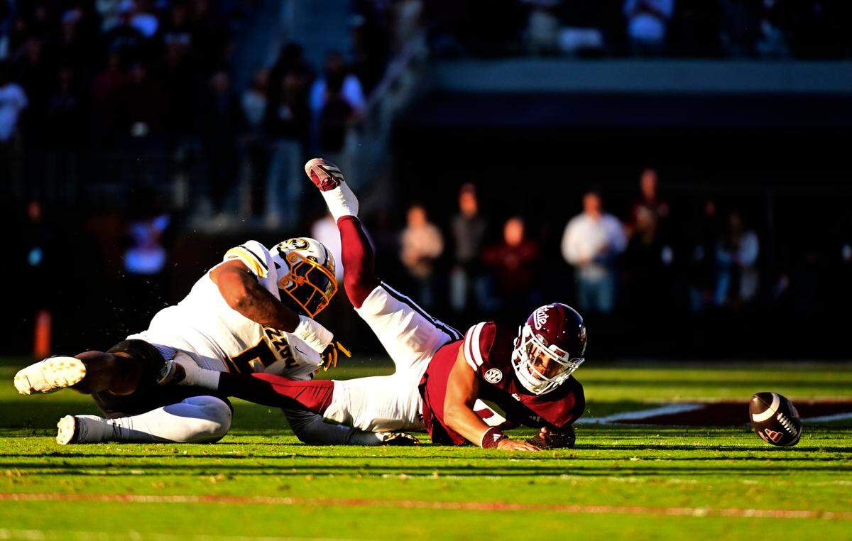 Missouri Tigers defensive tackle Kristian Williams, left, hits Mississippi State Bulldogs quarterback Michael Van Buren Jr., causing a fumble. MU’s Daylan Carnell scooped up the loose ball and returned it 68 yards for a defensive TD during an SEC college football game at Davis Wade Stadium at Scott Field on Saturday, Nov. 23, 2024 in Starkville, Mississippi.