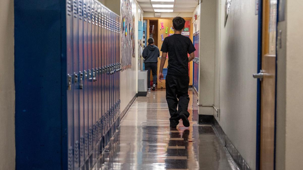 Students walk down a hall at Central Middle School on Tuesday, April 16, 2024, in Kansas City, Kansas.